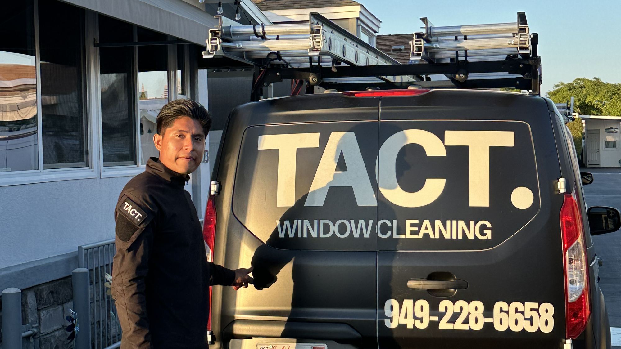 TACT crew member in uniform with cleaning equipment