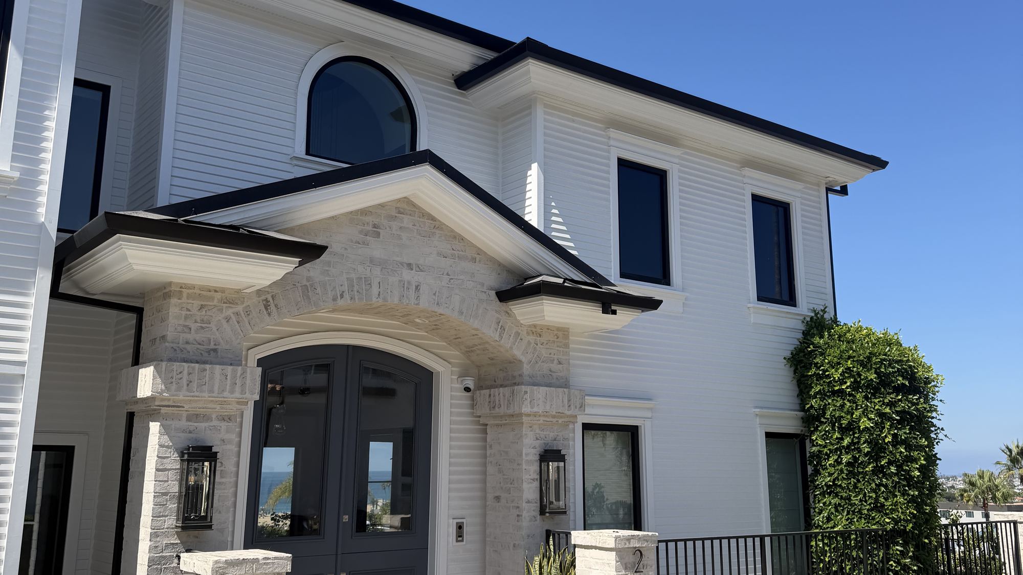 Freshly soft-washed stucco and trim on a luxury home