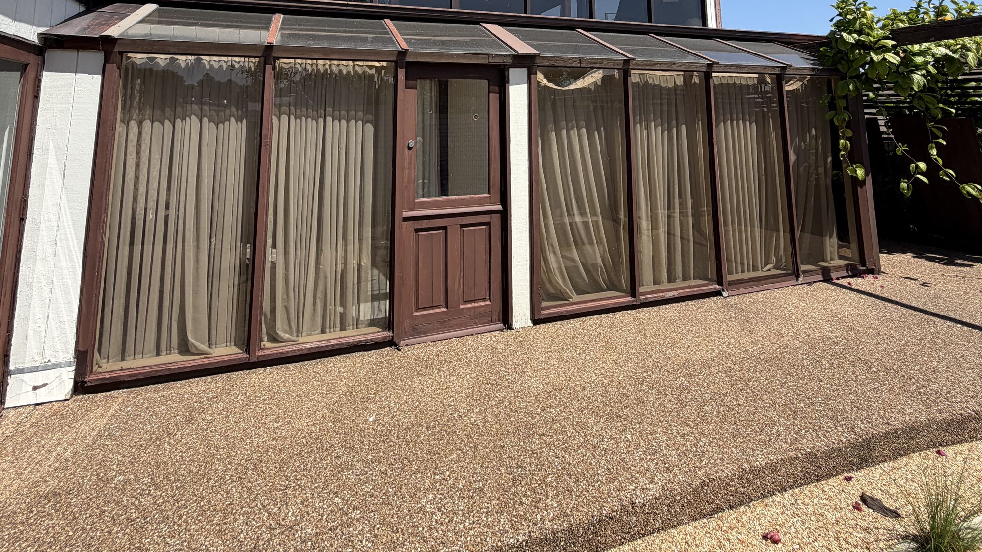 Pressure-washed driveway and walkway in front of a coastal home
